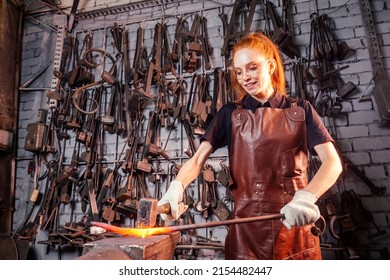 redhead ginger woman blacksmith portrait in workshop - Powered by Shutterstock