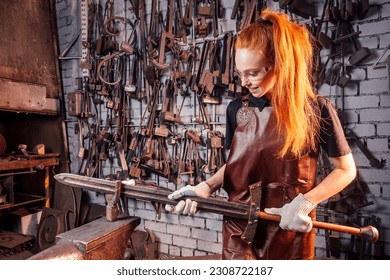 redhead ginger woman blacksmith portrait in workshop - Powered by Shutterstock