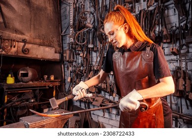 redhead ginger woman blacksmith portrait in workshop - Powered by Shutterstock