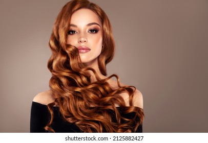 Redhead  girl with long  and   shiny wavy red hair .  Beautiful  model with curly hairstyle - Shutterstock ID 2125882427