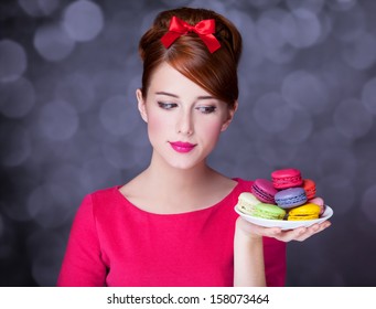 Redhead girl with macaron for St. Valentine Day. - Powered by Shutterstock