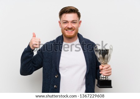 Redhead man holding a trophy