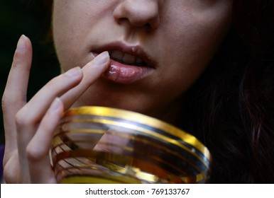 Redhead model using a homemade lip scrub made out of honey, sugar and olive oil 
