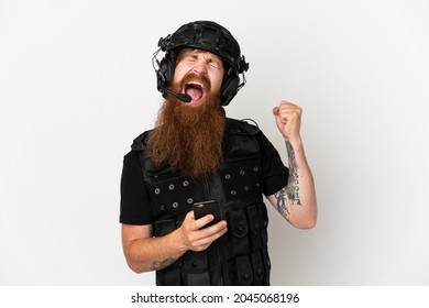 Redhead SWAT Isolated On White Background With Phone In Victory Position