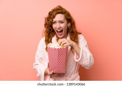 Redhead Woman In Dressing Gown Eating Popcorns