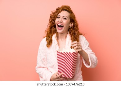 Redhead Woman In Dressing Gown Eating Popcorns