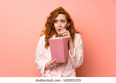 Redhead Woman In Dressing Gown Eating Popcorns