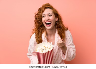 Redhead Woman In Dressing Gown Eating Popcorns