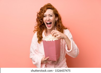 Redhead Woman In Dressing Gown Eating Popcorns