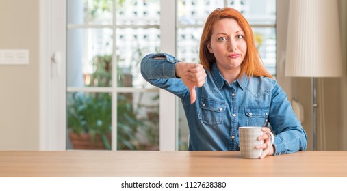 Redhead Woman Holding A Cup Of Coffee With Angry Face, Negative Sign Showing Dislike With Thumbs Down, Rejection Concept