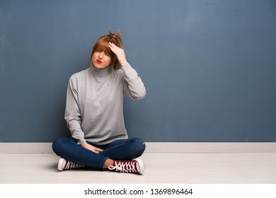 Redhead woman siting on the floor with tired and sick expression - Powered by Shutterstock