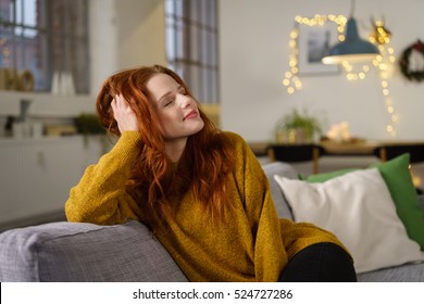 Redhead Woman Sitting At Home In Winter Holidays Leaning Her Head On Her Hand