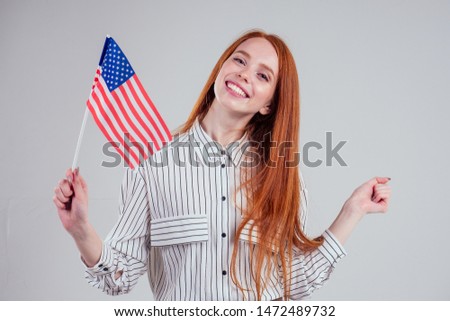 redhead woman in striped shirt USA visa traveler white background studio