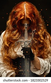 A redhead woman with a war sword (rapier) prays while holding a sword . The heroine of a historical adventure novel.
