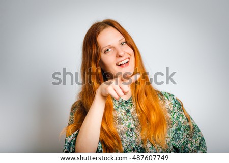 Redhead young woman mocks you, isolated close-up