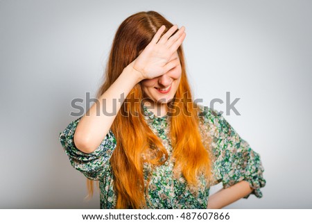 Redhead young woman mocks you, isolated close-up