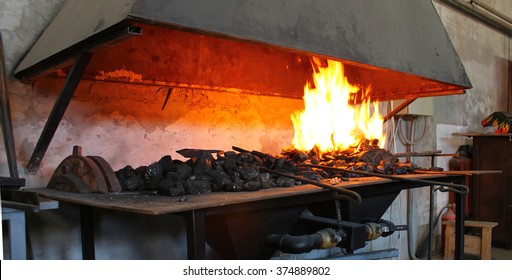 The red-hot billet on the anvil. Furnace for heating and melting metal. Forge iron. Blacksmiths master. - Powered by Shutterstock