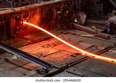 Red-hot metal billet on the roller table of a rolling mill - Shutterstock ID 2054468630