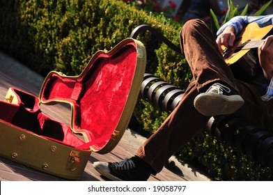 Red-lined Guitar Case Of A Street Musician Sitting On A Bench