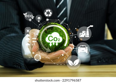 Reduce CO2 emission concept in the businessman hand with icons, global warming for environmental.Net zero and carbon neutral concept. - Shutterstock ID 2291796587