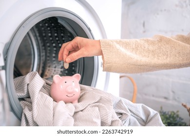 Reduce household bills expenses, money savings piggy bank. Washing machine energy electricity crisis - Powered by Shutterstock