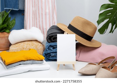 Reduce and reuse concept. Preparing clothes for swap. Waste problem in fashion industry. Vertical storage of clothing, tidying up, garments declutter and sorting. Copy spase