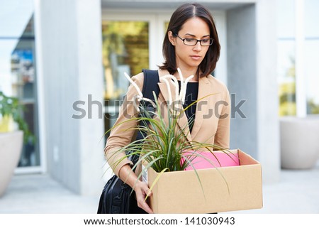 Redundant Businesswoman Leaving Office With Box