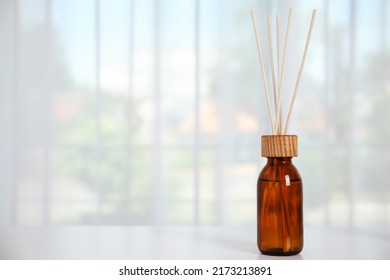 Reed Diffuser On White Table Against Window In Room. Space For Text