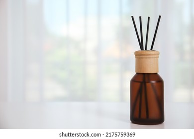 Reed Diffuser On White Table Against Window In Room. Space For Text