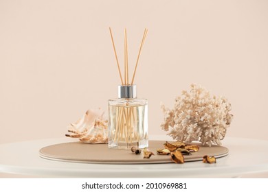 Reed diffuser and sea shells on table in room
