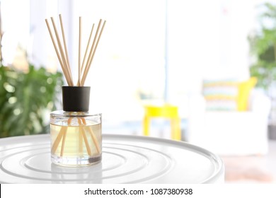 Reed freshener on table in light room, closeup