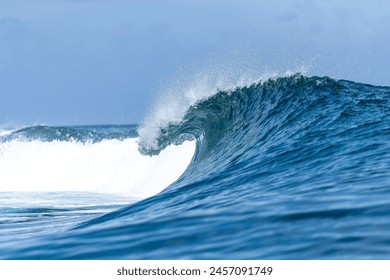 Reef break wave, a perfect surfing wave breaking and peeling down the coral lagoon pass.  - Powered by Shutterstock