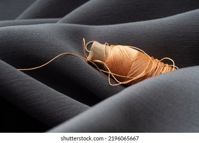 Reel with coral threads on gray silk fabric, macro, texture, close-up. Luxurious bright beautiful background for sewing. Tailoring, the concept of the atelier. High fashion, natural fabrics - Shutterstock ID 2196065667