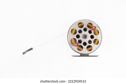 Reel With Fishing Line For Spinning Isolated On White Background