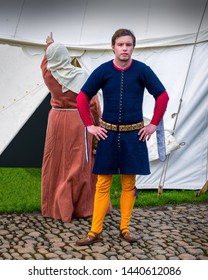 A Re-enactment Medieval Squire Poses For The Cameras Will His Wife Complains About The Leaking Tent, The Encampment 