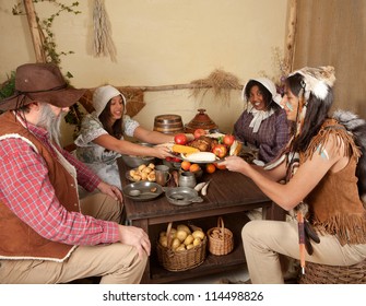 Reenactment Scene Of The First Thanksgiving Dinner In Plymouth In 1621 With A Pilgrim Family And A Wampanoag Indian