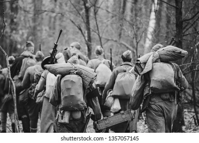 Re-enactors Dressed As World War II Russian Soviet Red Army Soldiers Marching Through Forest In Autumn Day. Photo In Black And White Colors. Soldier Of WWII WW2 Times.