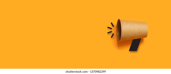 Refer a Friend. Business concept image with paper cup on orange background with copy space. Minimal flat lay