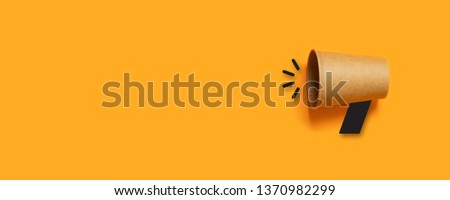Refer a Friend. Business concept image with paper cup on orange background with copy space. Minimal flat lay