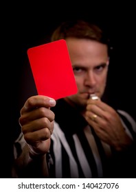 Referee Holding Red Card For Foul Concept