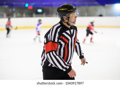 Referee is judging a match on ice hockey