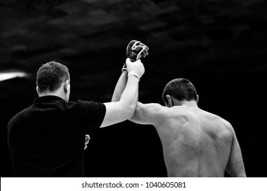 referee lifting hand of winner fighter MMA black-and-white image - Powered by Shutterstock