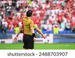 Referee shows yellow card during soccer match at the stadium