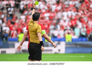 Referee shows yellow card during soccer match at the stadium - Powered by Shutterstock