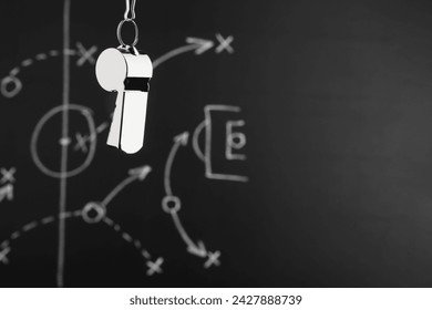 Referee whistle against chalkboard with game scheme, closeup. Space for text - Powered by Shutterstock