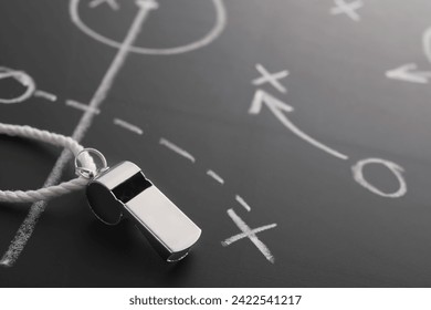 Referee whistle on chalkboard with game scheme, closeup - Powered by Shutterstock