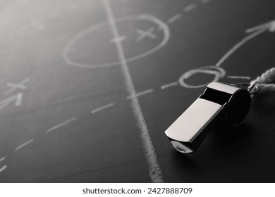 Referee whistle on chalkboard with game scheme, closeup. Space for text - Powered by Shutterstock