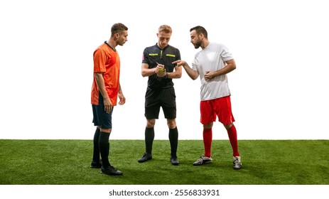 Referee writes in his notebook as two players, in orange and white jerseys, point and argue during match, isolated on white background. Concept of sport, fair play, competition, control, rules - Powered by Shutterstock