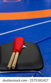 The referee's red and white flags are waiting for the referee on the chairs. The concept of the Kyokushin karate competition.
