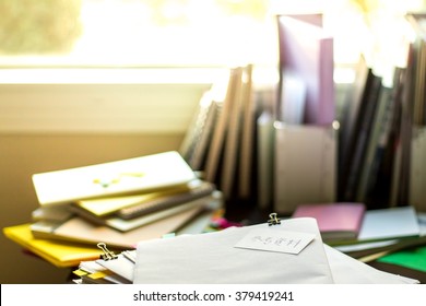 Reference Materials; Stack Of Documents. Working Or Studying At Messy Desk.